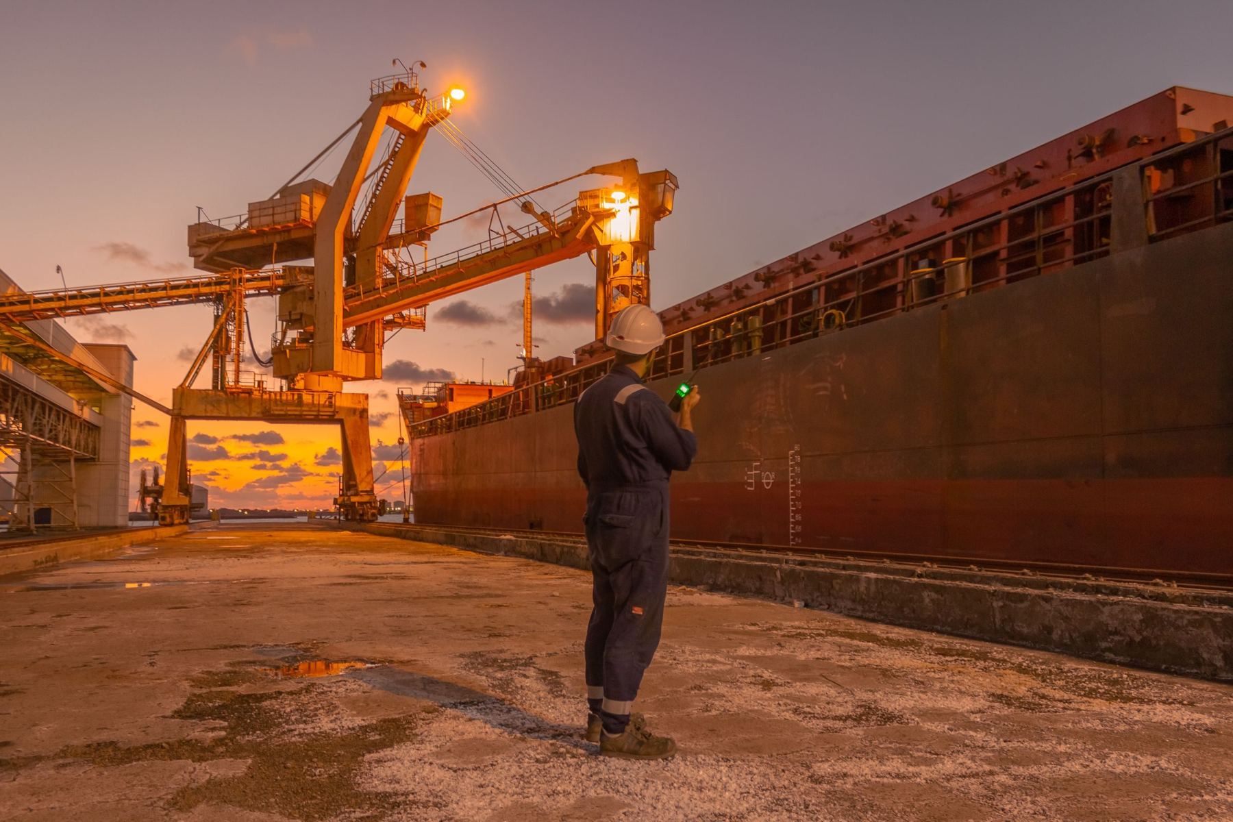 Marine engineer at a port terminal at dusk